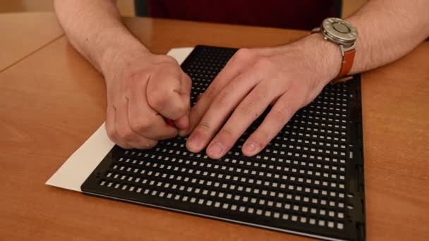 Muž Používá Speciální Šablonu Stylus Napsat Dopis Braillu — Stock video