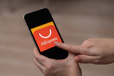 3 Aralık 2022 Almaty Kazakistan: Ekranda Ali ekspres logosuyla akıllı telefon tutan yüzsüz kadın