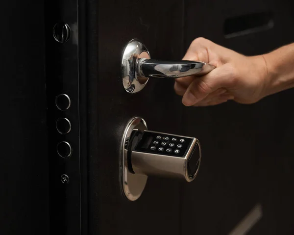 Woman opens the combination lock on the door to the apartment. Keyless entry