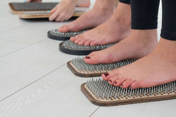 Close-up of three womens feet on sadhus nails