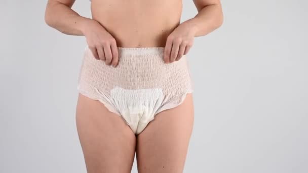 Faceless Woman Adjusts Elastic Adult Diapers Incontinence Problem — Stock Video