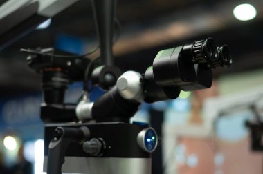 Black dentists microscope at a medical exhibition