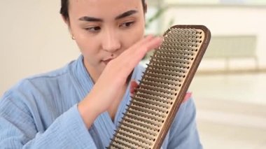 Asian woman touching Sadhus wooden boards with nails