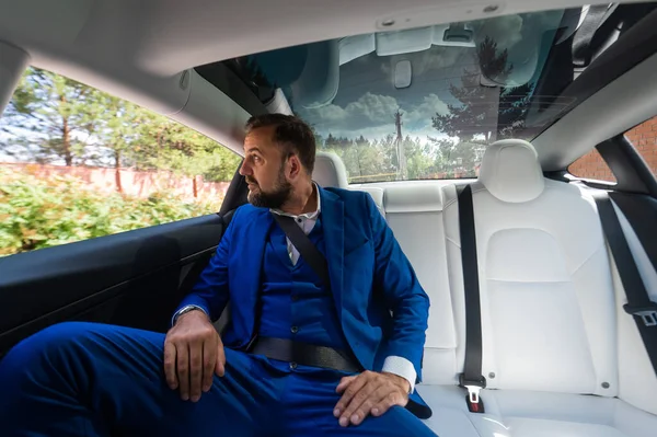 Caucasian Man Blue Suit Sits Back Seat Car Business Class — Stock Fotó