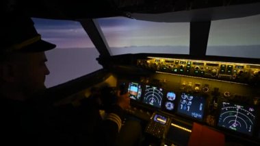 A man is studying to be a pilot in an aircraft simulator