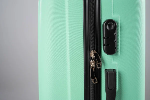 Close-up of a combination lock of a mint plastic suitcase