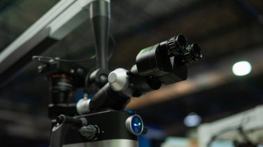 Black dentists microscope at a medical exhibition