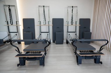 Two reformer machines. Pilates studio without people