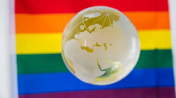 Crystal globe on a rainbow flag. LGBT community