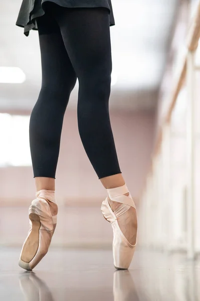 Close-up but ballerinas in pointe shoes in a dance class