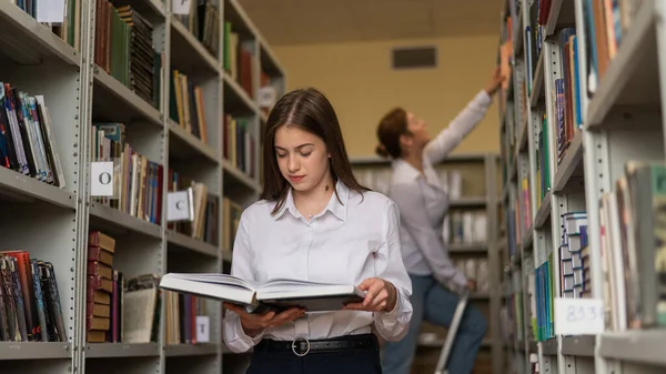 stock image Two young female students in a public library