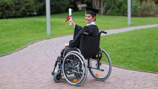 Happy Caucasian Woman Wheelchair Turns Holds Her Diploma Outdoors — Photo