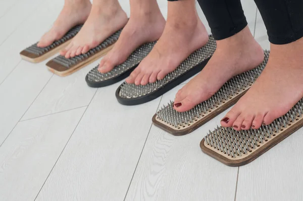 stock image Close-up of three womens feet on sadhus nails