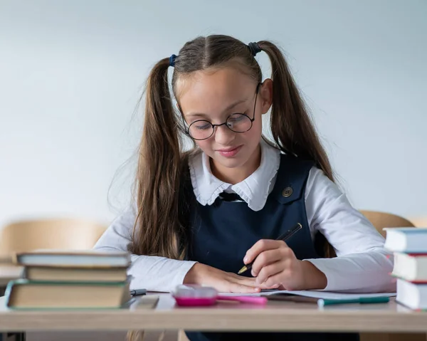 Caucasian Girl Two Ponytails Sits Her Desk Writes Workbook — Stock Photo, Image