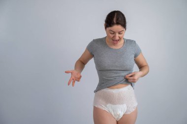 A woman in adult diapers. Urinary incontinence problem