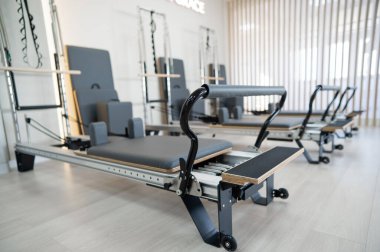 Two reformer machines. Pilates studio without people