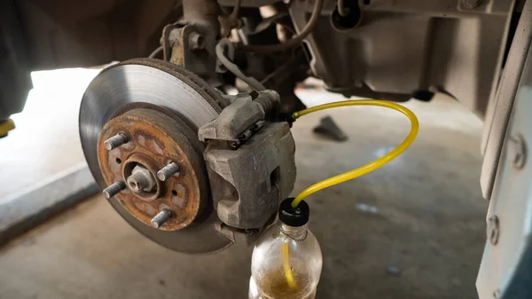 Automatic change of brake fluid in a car service