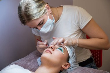 Kirpik kaplama prosedüründeki bir kadının yakın plan portresi