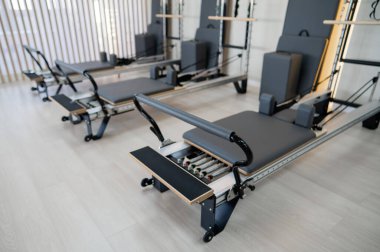 Two reformer machines. Pilates studio without people