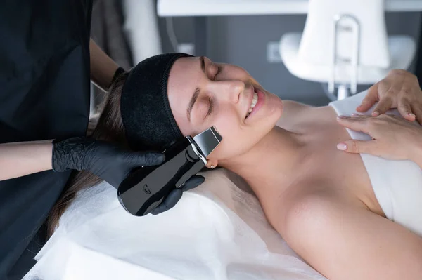 stock image Woman on ultrasonic cleaning procedure. Hardware cosmetology