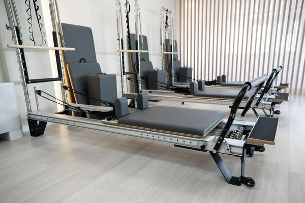 Two reformer machines. Pilates studio without people