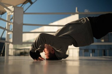 Caucasian male boxer warming up before a fight in the ring outdoors