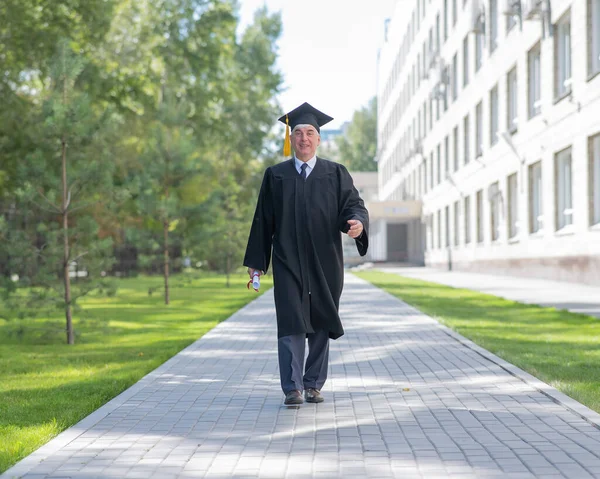 Old Man Graduation Gown Walks Outdoors Holds Diploma — Photo