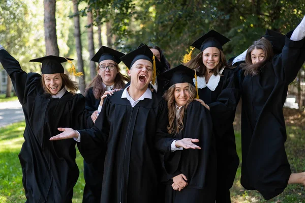 Group Graduates Robes Congratulate Each Other Graduation Outdoors — Fotografia de Stock