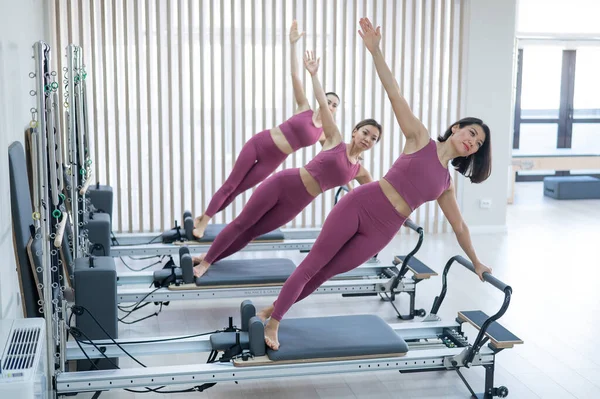 Balanced Body Pilates Arc. Three Asian Women Exercising on Pilates Arc.  Stock Photo - Image of flexibility, plastic: 281342872
