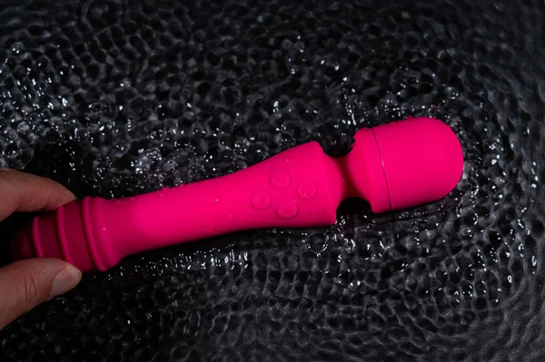 Woman Holds Pink Dildo Water Sex Toy Black Background — Stock fotografie
