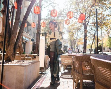 Full length portrait of Asian woman in front of Chinese lanterns