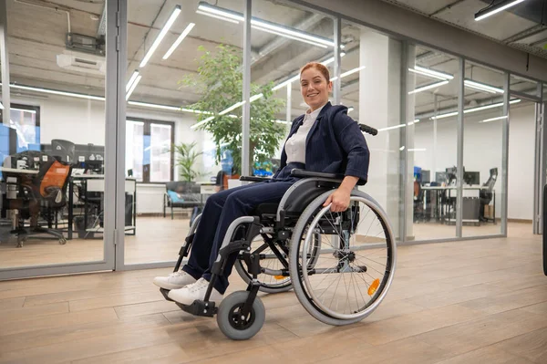 stock image Caucasian woman wheelchair in open space office