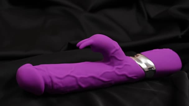 Womans Hand Takes Purple Dildo Black Silk Sheet — ストック動画