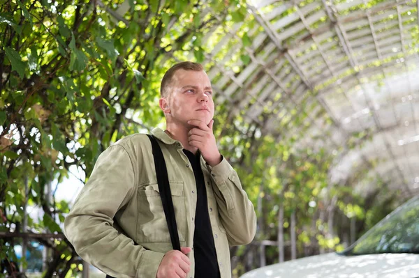 Young caucasian man with hearing device walking outdoors