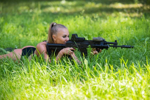Caucasian Woman Bikini Lies Machine Gun Green Grass — Stock fotografie
