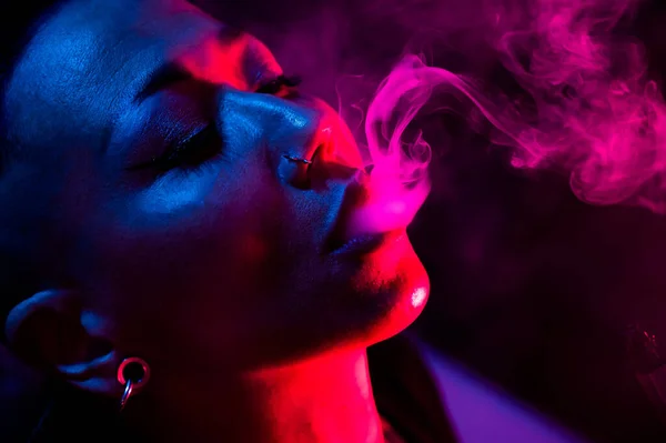 Stock image Asian woman with short haircut smoking in neon light. close-up portrait