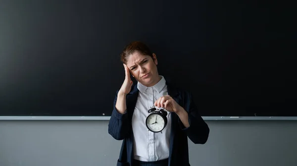Mutsuz Öğretmen Takım Elbiseli Elinde Çalar Saatle Tahtada Dikilirken — Stok fotoğraf