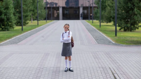 Een Verdrietig Blank Meisje Uniform Met Een Rugzak Houdt Haar — Stockfoto