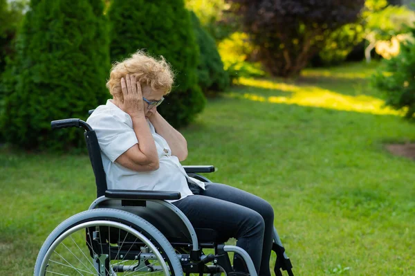 Unhappy Elderly Woman Crying While Sitting Wheelchair Walk Outdoors — Stockfoto