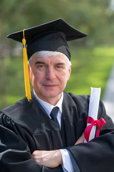 Portrait Elderly Man Graduation Gown Diploma His Hands Outdoors Vertical — Stock Photo, Image