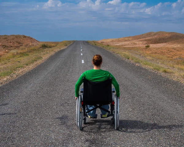 Bozkırlarda Otoyolda Tekerlekli Sandalyedeki Kadın — Stok fotoğraf