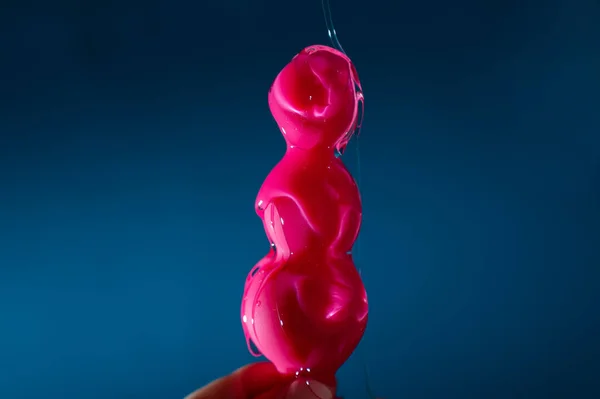 Woman Pouring Lubricant Pink Anal Beads Blue Background — Stock Photo, Image