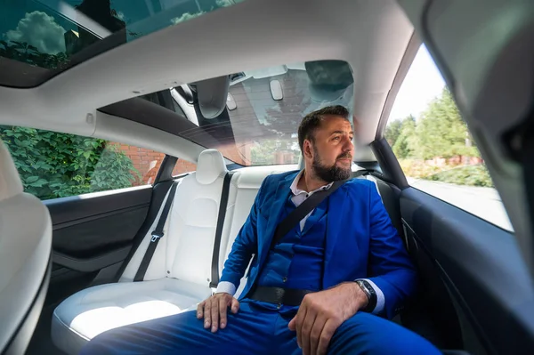 Caucasian Man Blue Suit Sits Back Seat Car Business Class — Foto de Stock