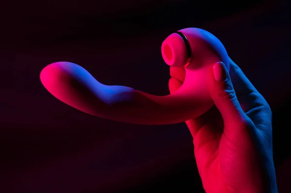 stock image Woman holding a vibrator in neon pink and blue light