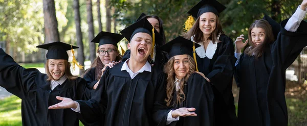 Group Graduates Robes Congratulate Each Other Graduation Outdoors — Stockfoto