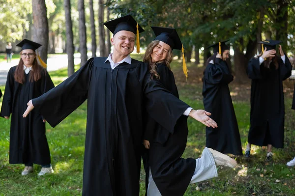 Group Happy Young People Graduation Gowns Outdoors Students Walking Park — Stock Photo, Image