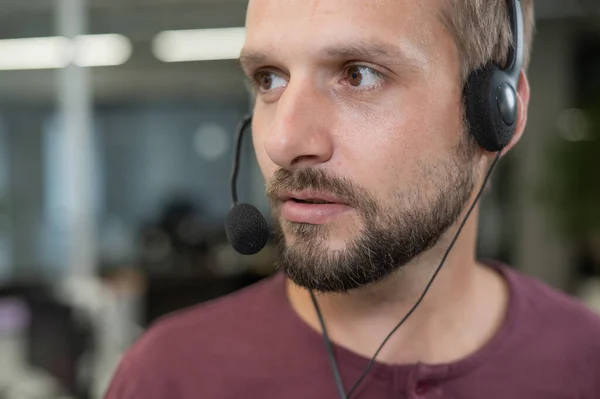 stock image Caucasian bearded man with a headset. Male call center worker.