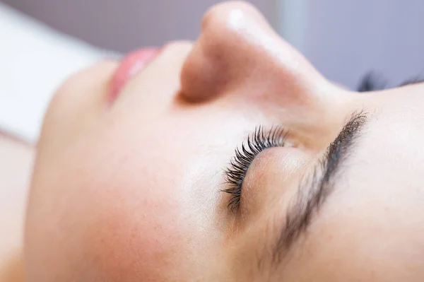 Close-up of a caucasian woman after eyelash lamination procedure