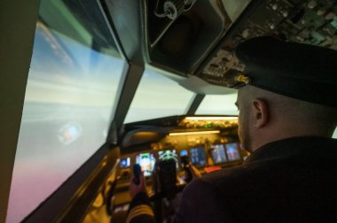 A man is studying to be a pilot in an aircraft simulator