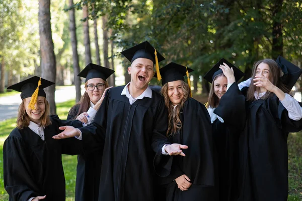 Group Graduates Robes Congratulate Each Other Graduation Outdoors — Φωτογραφία Αρχείου
